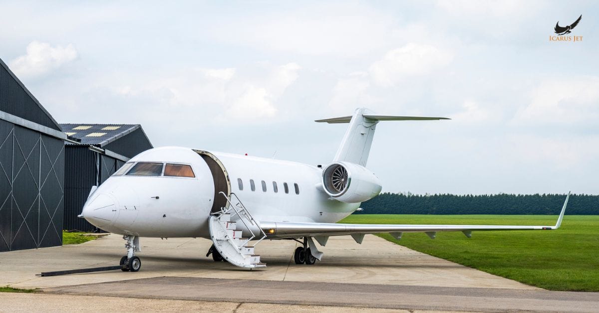 private jet parked near hangar with stairs open