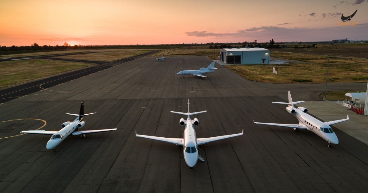 fleet of private jets parked on airport apron at sunset