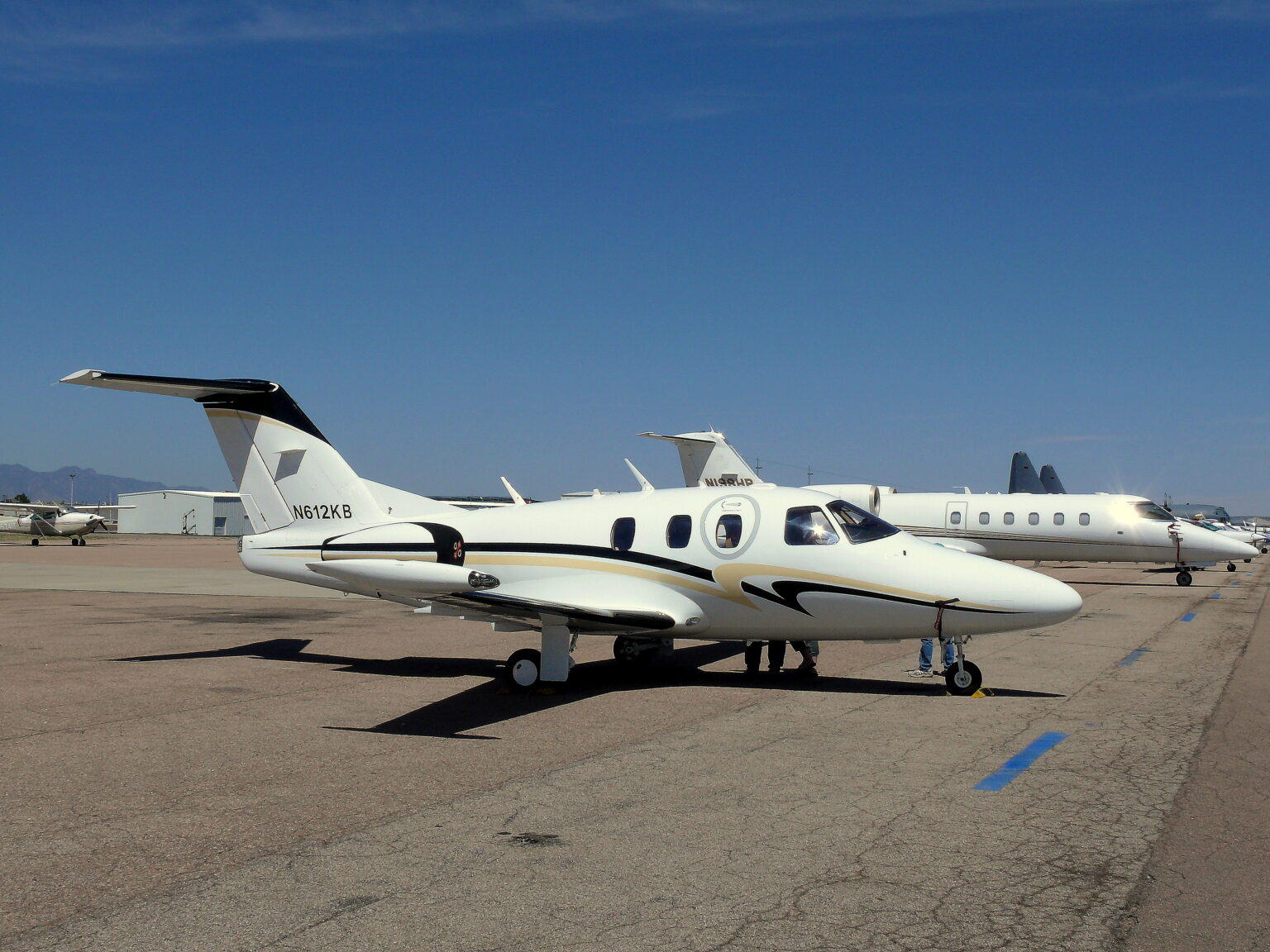 Al Bateen Executive Airport (AZI / OMAD): eclipse light jet parked on the apron at a coastal airport