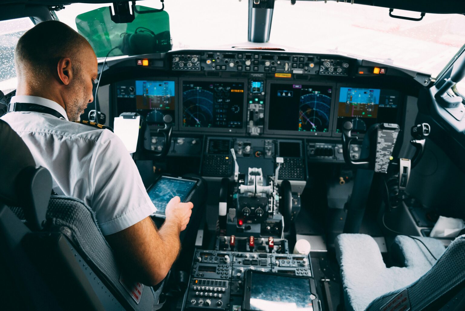 Prince Mohammad bin Abdulaziz International Airport (MED / OEMA): pilot in the cockpit reviewing international permit documents on a tablet